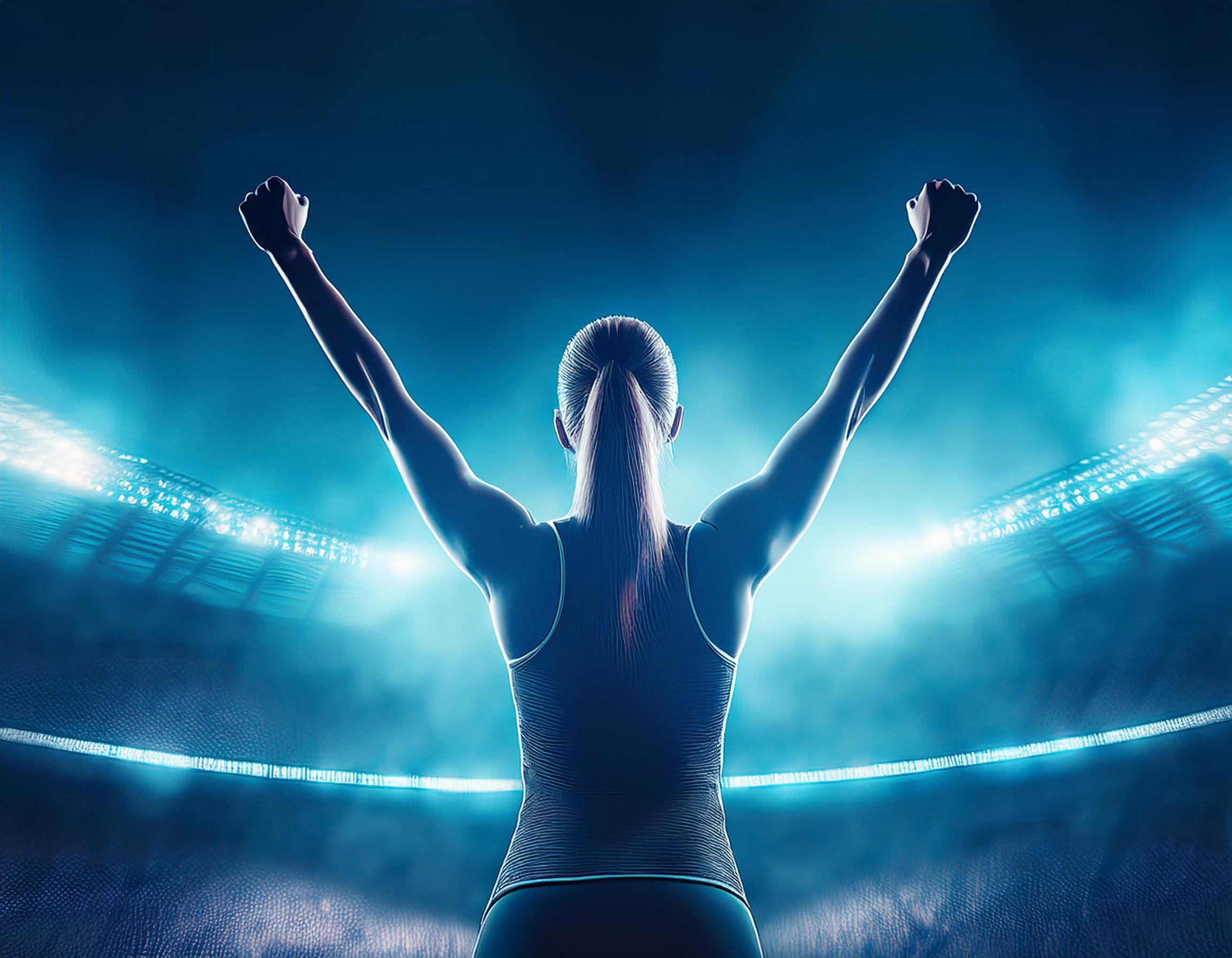 Woman in stadium with arms up